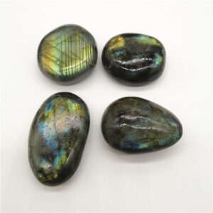 Four polished labradorite stones with blue-green iridescent flashes on a white background, arranged in a square.