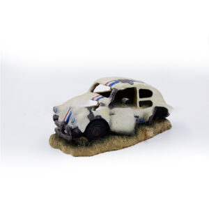 Small Toy Car Wreck on a Sandy Base, White with Red and Blue Stripes.