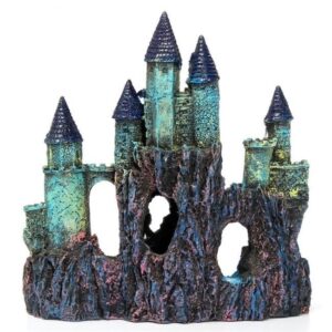 Colorful castle-shaped fish tank ornament with blue-turquoise towers atop a rocky base featuring arches.