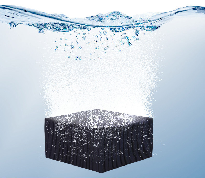 63407412-8281-42cd-9c92-3e7e0211f6e2-1jpg - Aquassi Ltd | Award-winning Aquarium Design & Aquascaping Black Rectangular Cube Underwater with Bubbles Rising to the Surface, Surrounding It in Clear Blue Water.