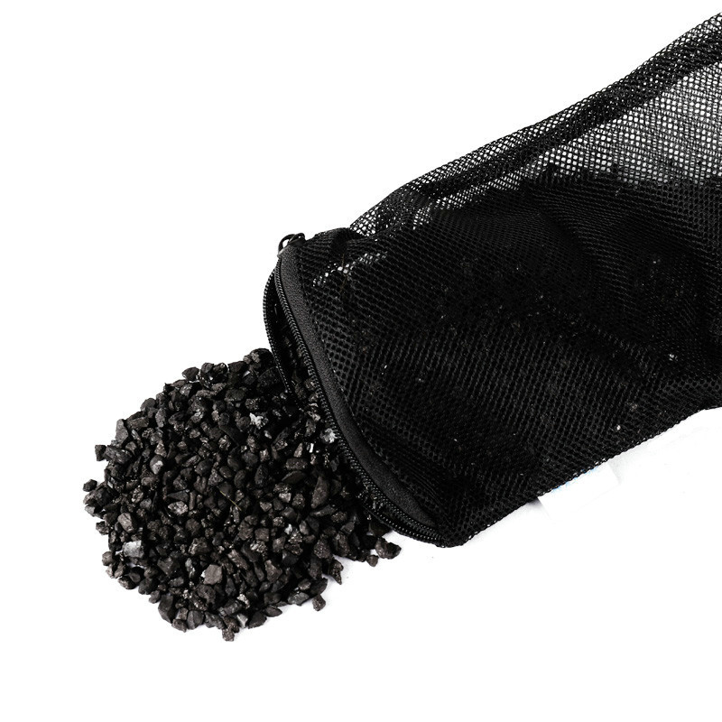 8eb38dc7-5951-4d07-8fc5-fa02d6956ae5-1jpg - Aquassi Ltd | Award-winning Aquarium Design & Aquascaping Black Mesh Pouch Tipped Over, Spilling Small Dark Gravel Stones Onto a White Background.